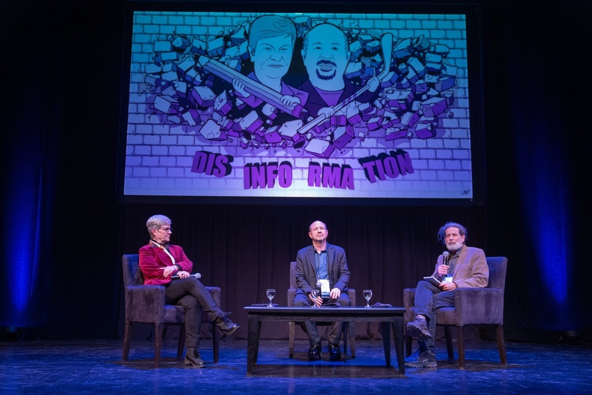 Kathleen Hall Jamieson, Michael Mann, and Rick Weiss seated on stage at an event