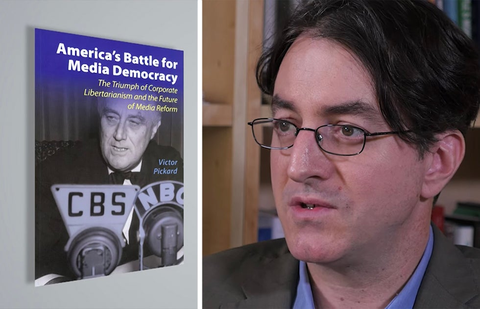 Victor Pickard with the cover of his book, "America's Battle for Media Democracy: The Triumph of Corporate Libertarianism and the Future of Media Reform"