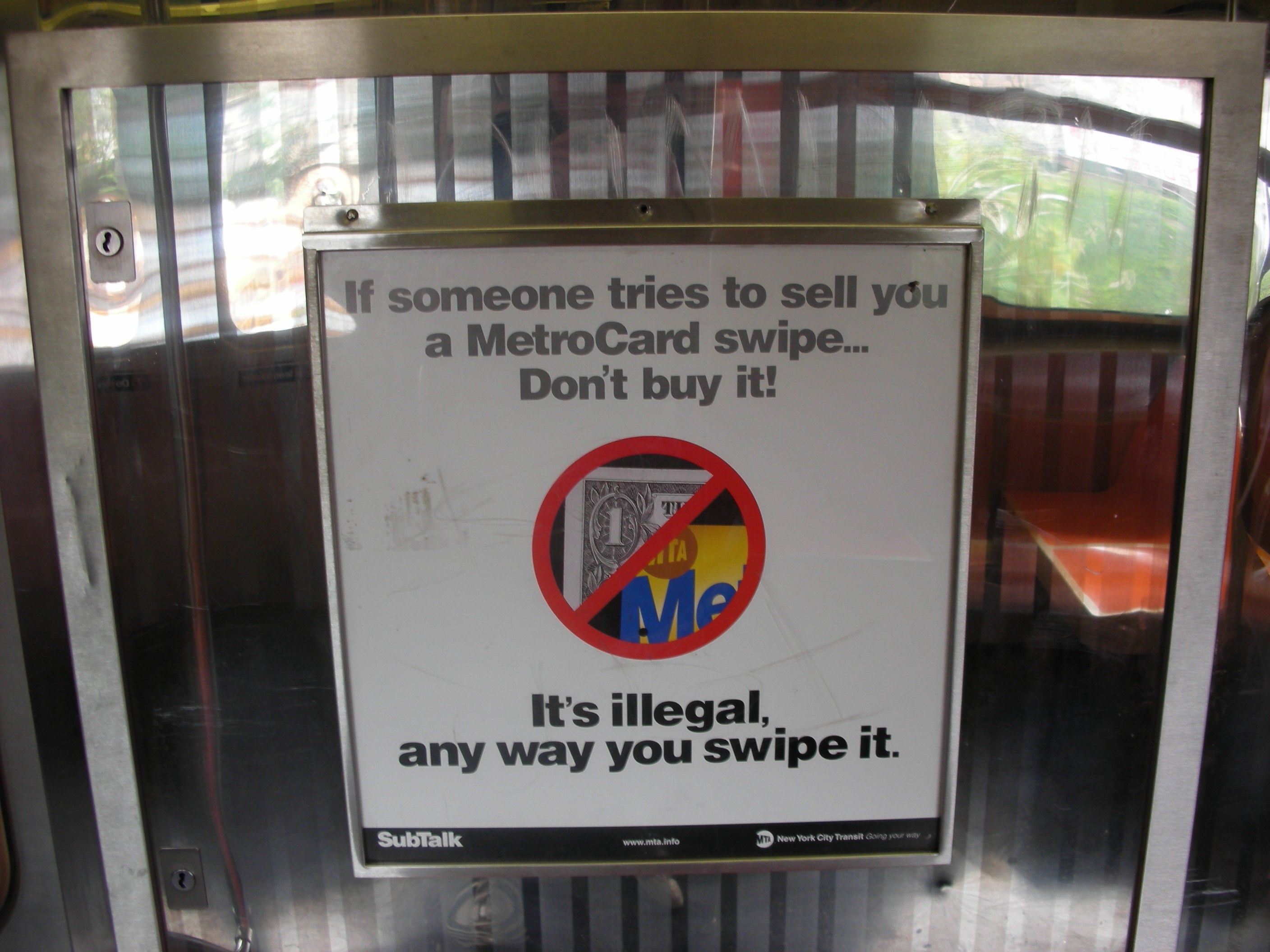 Sign at metro warning people not to buy a Metrocard swipe