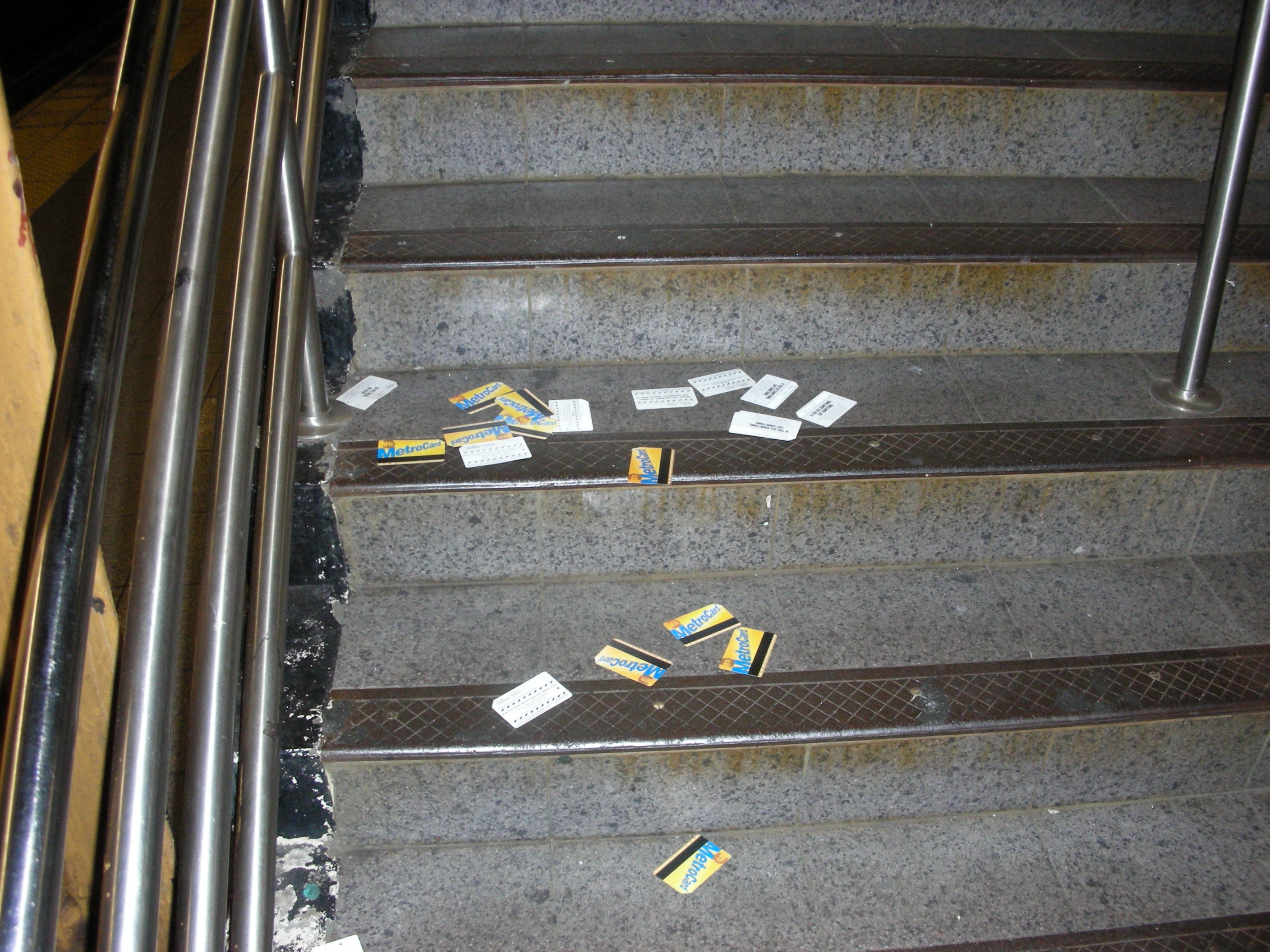Metrocards scattered on a stairwell in the New York City Subway