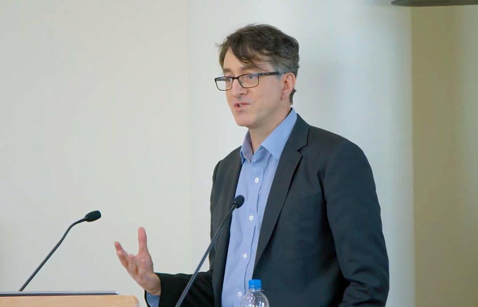 Victor Pickard speaking at a podium