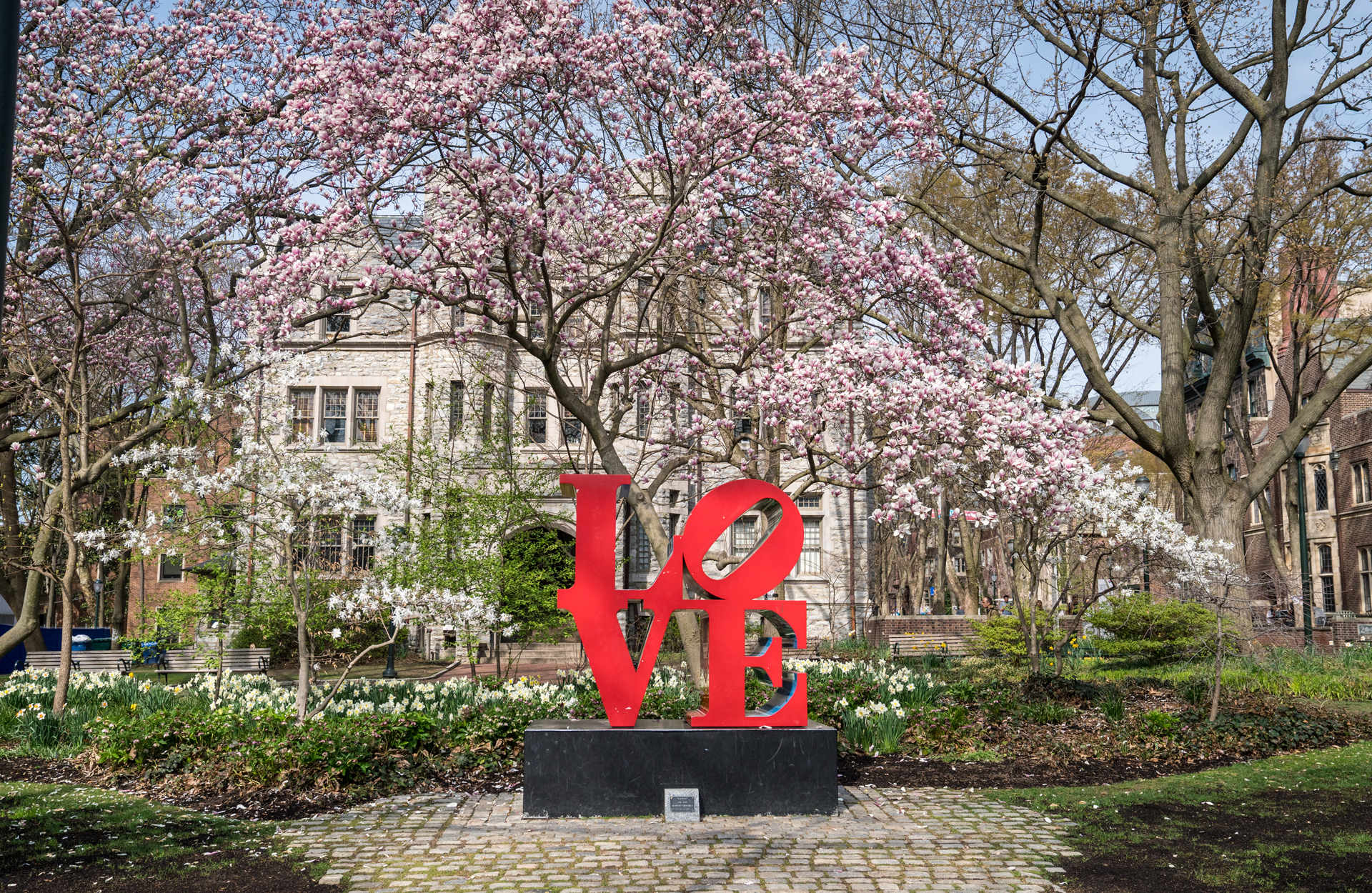 love sign 1920x1250.png statue of the word "love" in red on a spring day with Penn buildings and blossoming trees in the back