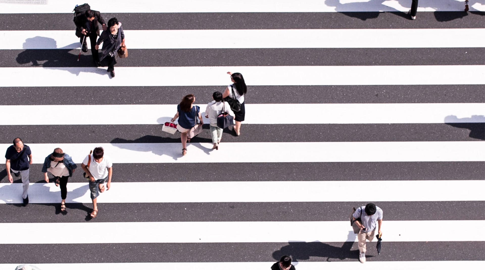 Aerial view of people walking in a crosswalk, photo credit Ryoji Iwata / Unsplash