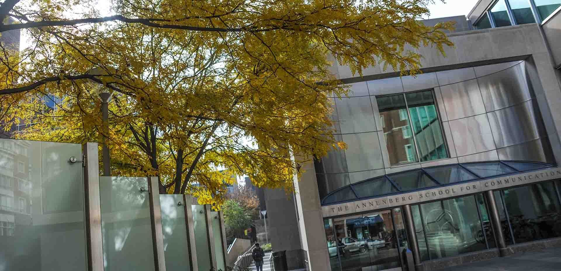 Walnut Street Entrance to the Annenberg School with fall leaves on a tree