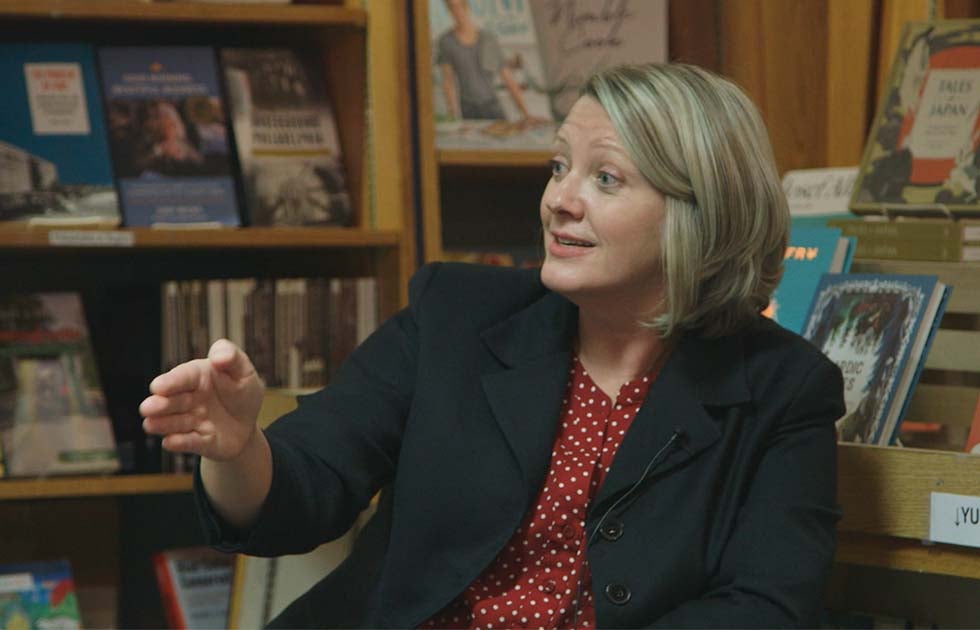 Dannagal Young gesturing while speaking in a bookstore