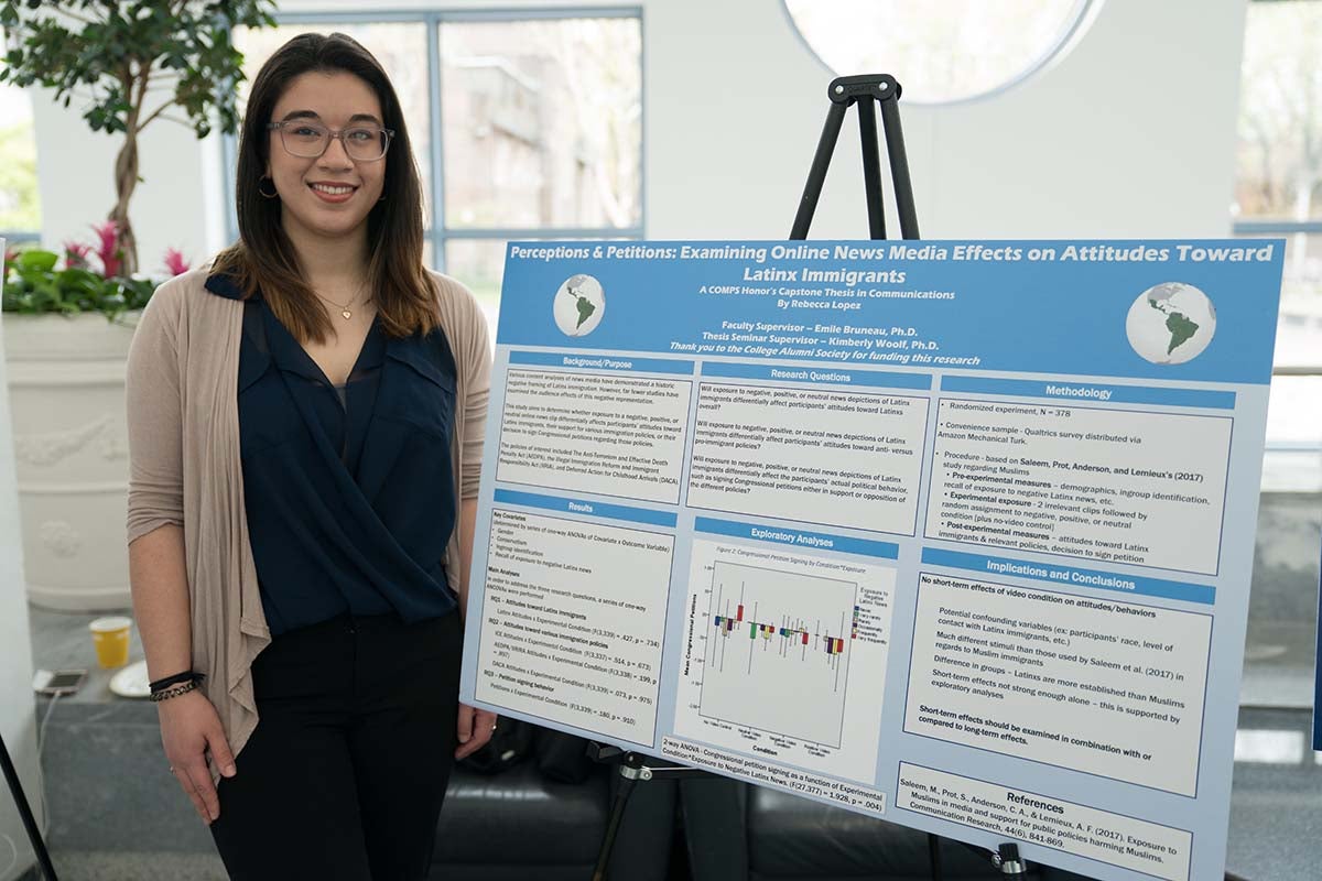 Rebecca López poses with thesis poster.