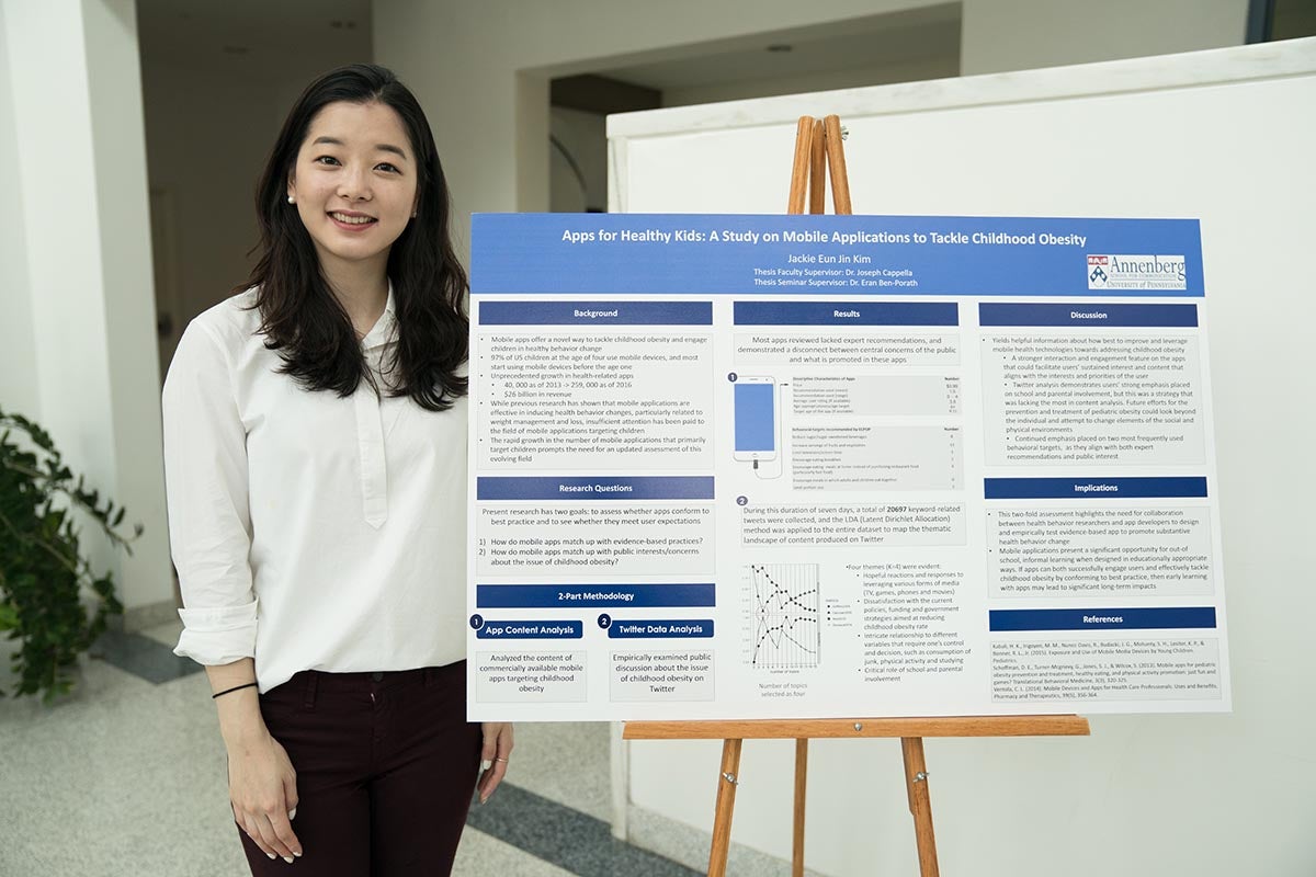 Jackie (Eun Jin) Kim poses with thesis poster.