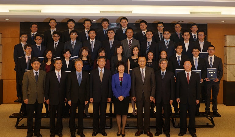 Group photo of awardees and important personnel at the event. They are standing in 4 rows. 