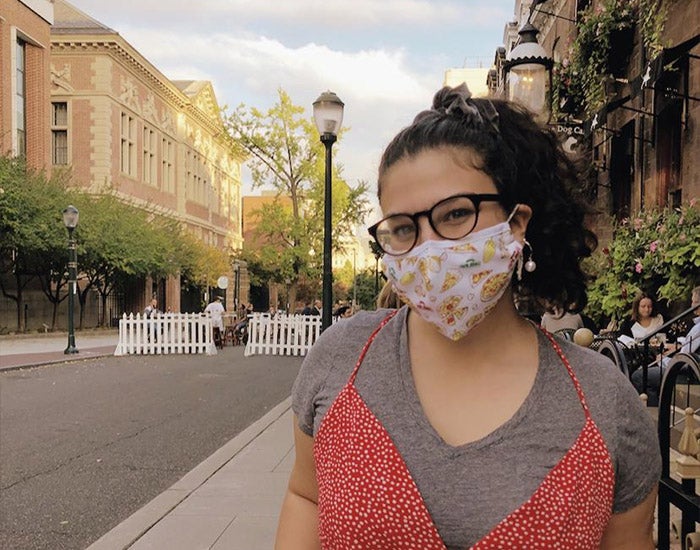 Jaden Baum wearing a mask seated on Sansom Street