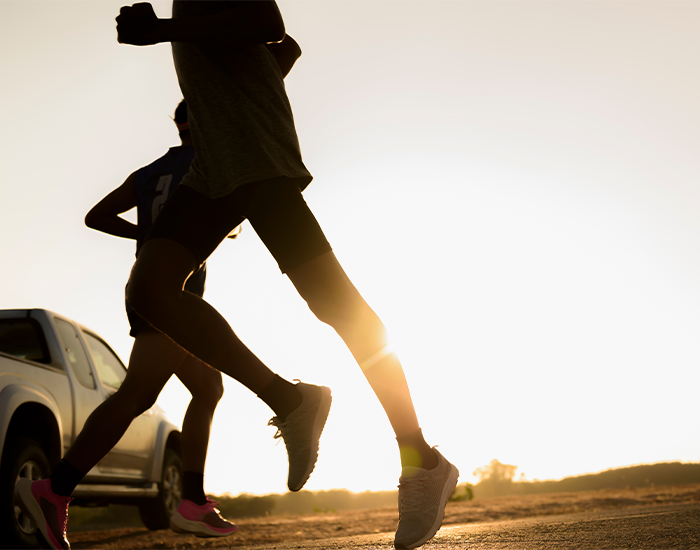 BehavioralChange_Checkerboard.png Silhouette of two joggers running in the sunset