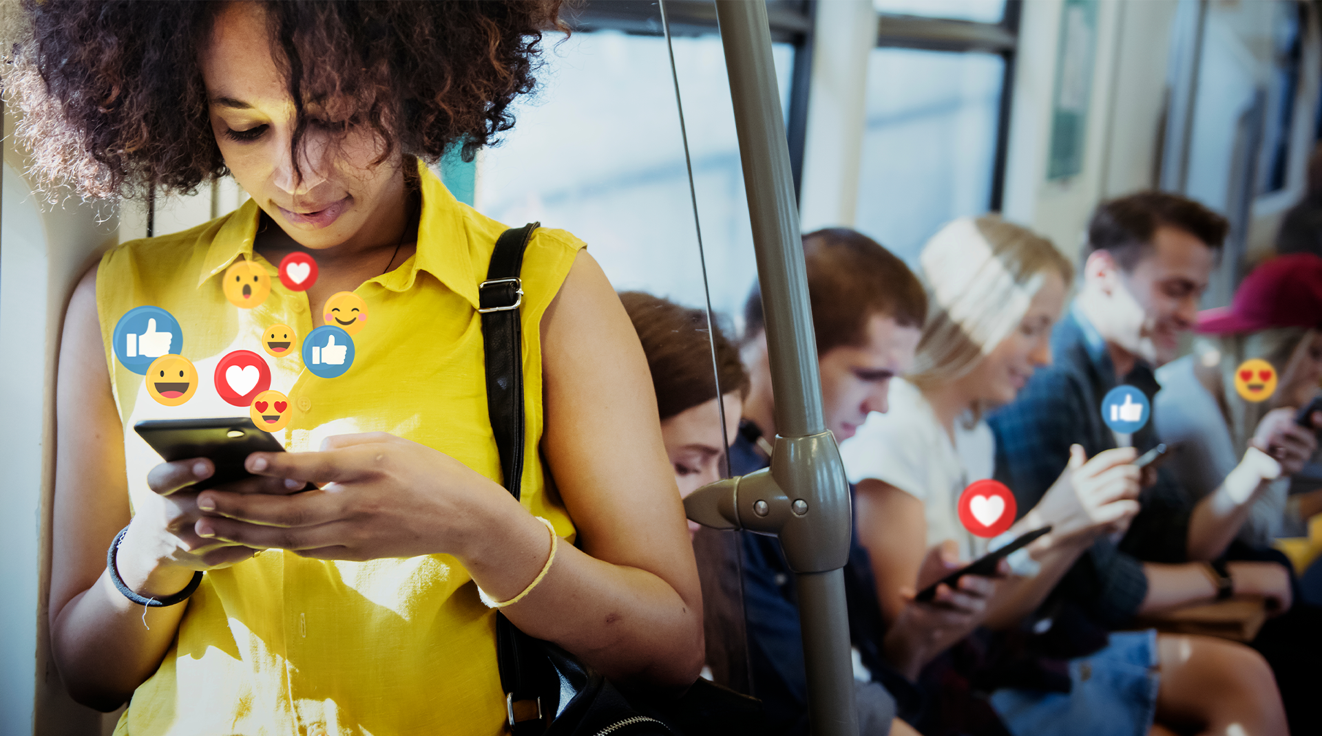 SAL_HSMTG_FW_1920x1070.png Woman on a public bus looking at her phone, and various social media "reaction" icons floating out of her phone to imply that she is engaging with social media