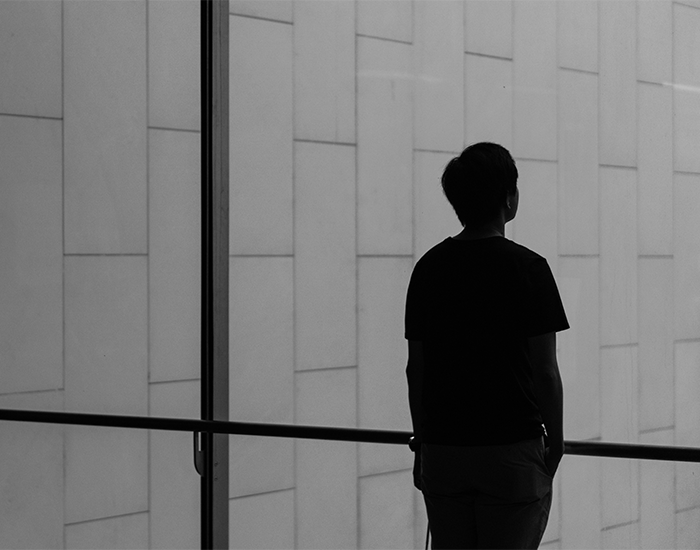 action-inaction_Checkerboard.png Silhouette of a person looking out a window from a modern building
