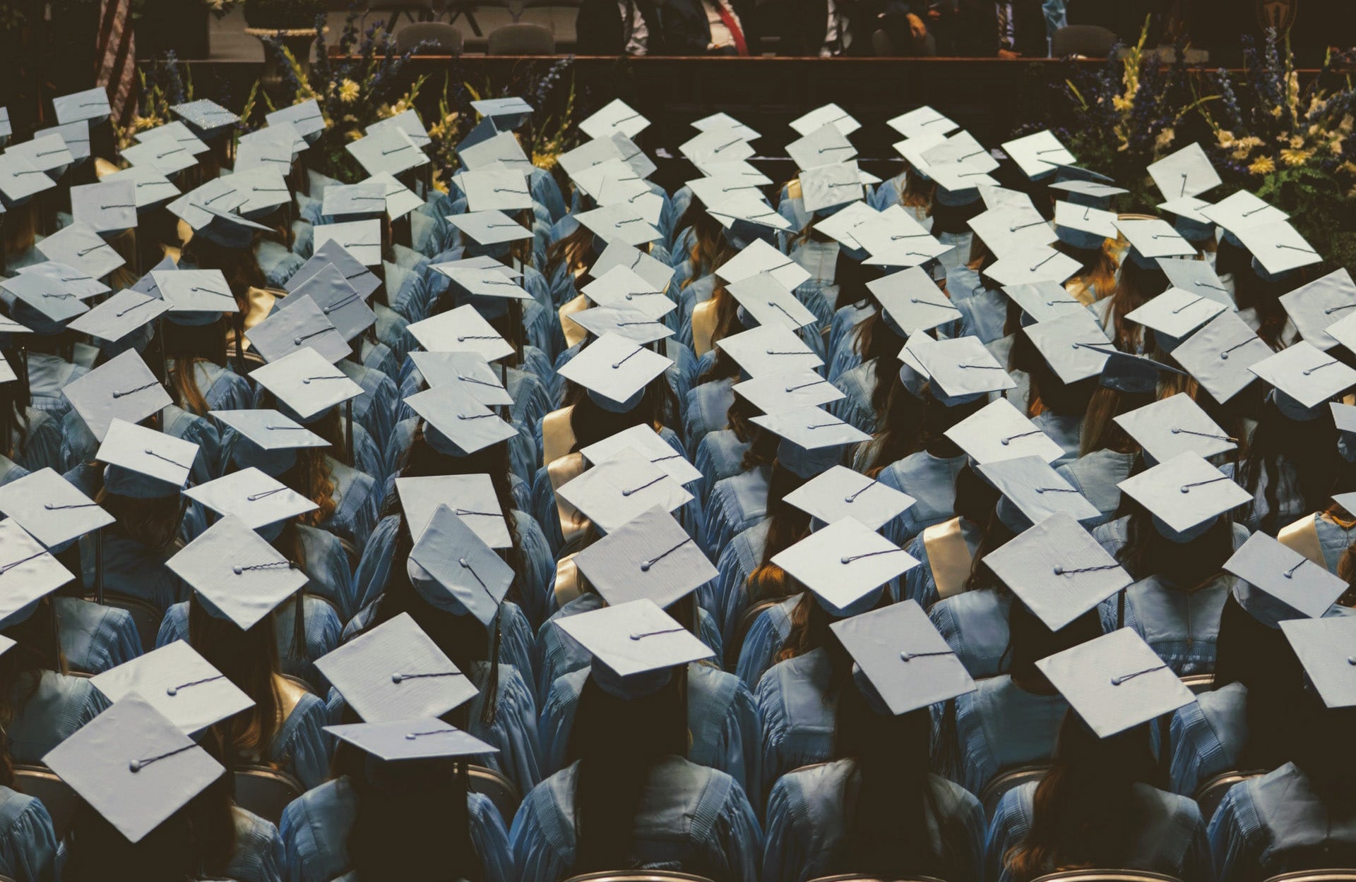 joshua-hoehne-iggWDxHTAUQ-unsplash_1920x1250.jpg rows of graduates from above; Photo by Joshua Hoehne on Unsplash