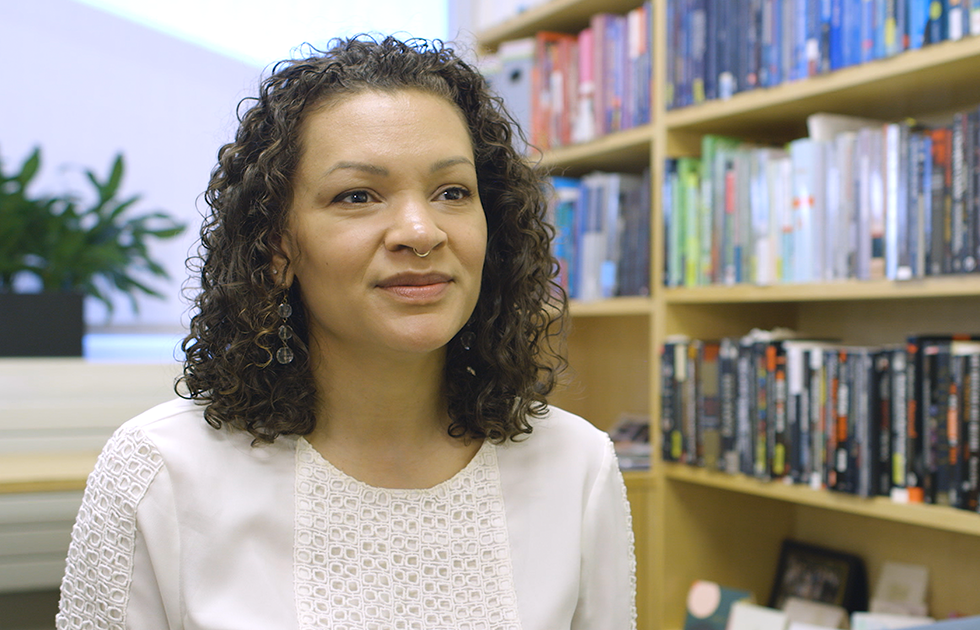 Sarah Jackson smiling with a bookshelf behind her