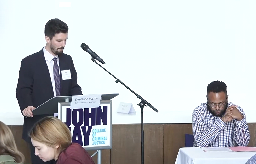 Dr. Desmond Patton being introduced at Justice Codes Symposium