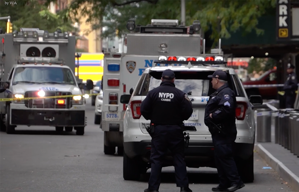 NYPD officers standing near crime scene