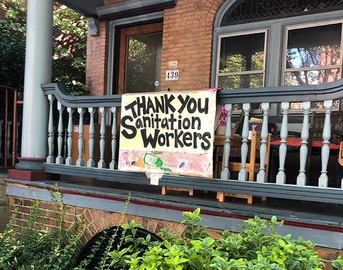 Homemade sign reading &quot;Thank you sanitation workers&quot; on a west philadelphia porch