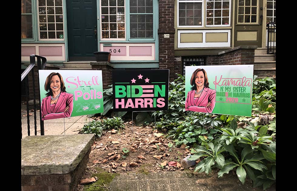 Lawn signs that have a portrait of Kamala Harris on them and say “Stroll to the Polls 2020” and “Kamala is my sister Biden Harris 2020”. Another says “Biden Harris” in pink and green