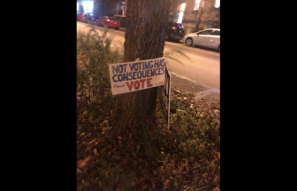 Handmade sign that says “Not voting has consequences please vote in 2020” next to an official campaign sign that says “Biden Harris 2020”