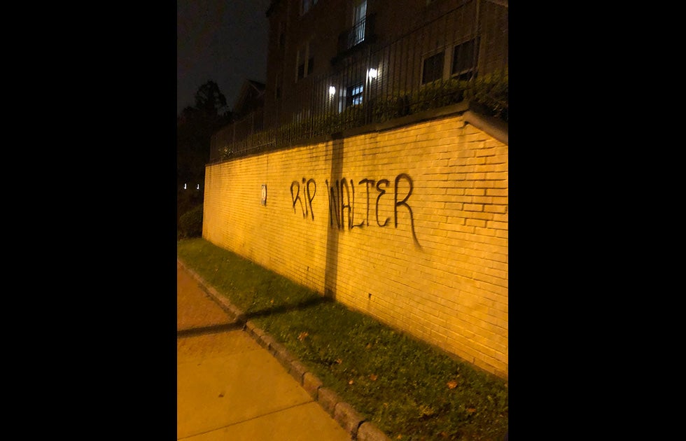 Brick wall outside apartment complex with RIP Walter spray painted. It is nighttime. NOTE: This was written on my apartment building shortly after the murder of Walter Wallace, Jr. by police in West Philadelphia.