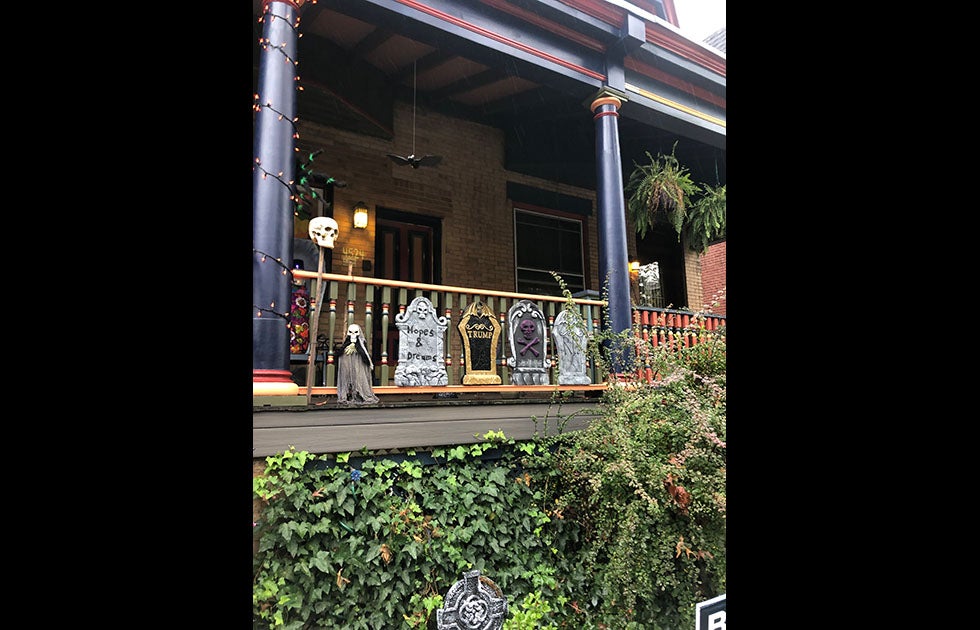 Halloween decorations on a porch. Some are skulls. Some are tombstones that say “Hopes &amp; Dreams” “Trump” “RIP” and one just has a skull and crossbones.