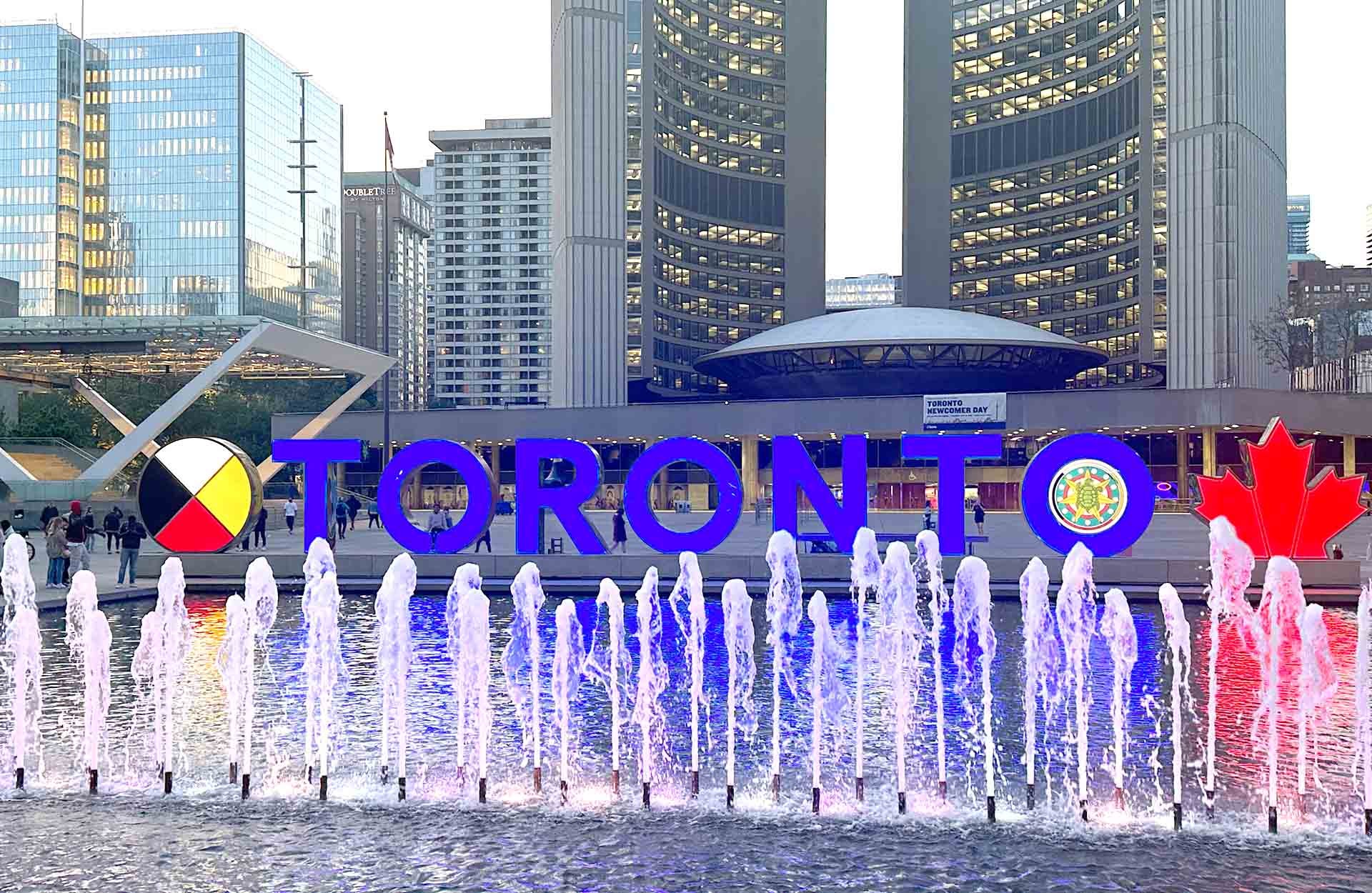 Toronto Sign 1920 x 1250.jpg Fountain and Toronto sign in Nathan Phillips Square with buildings behind it