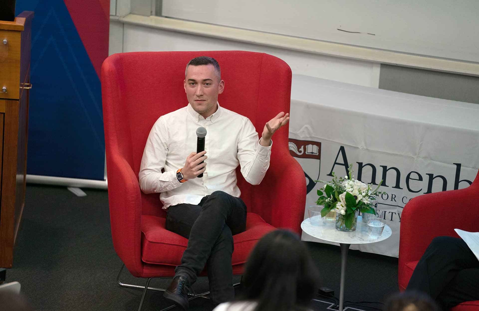 Yoel Roth 1920 x 1250.jpg Yoel Roth seated in a red chair speaking into a microphone