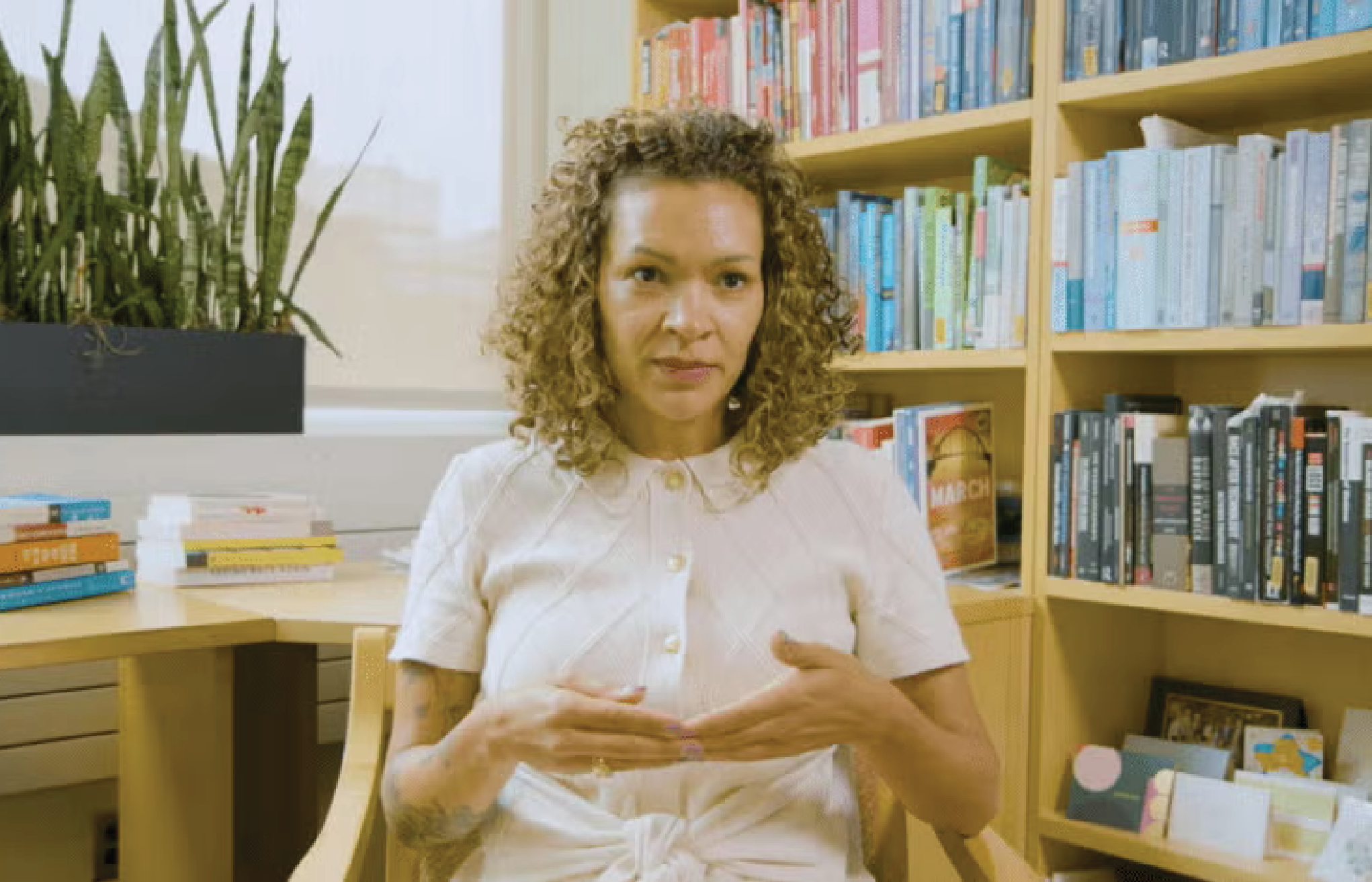 Sarah J. Jackson_Gallery Professor Sarah J. Jackson seated in an office with bookshelves in the background.