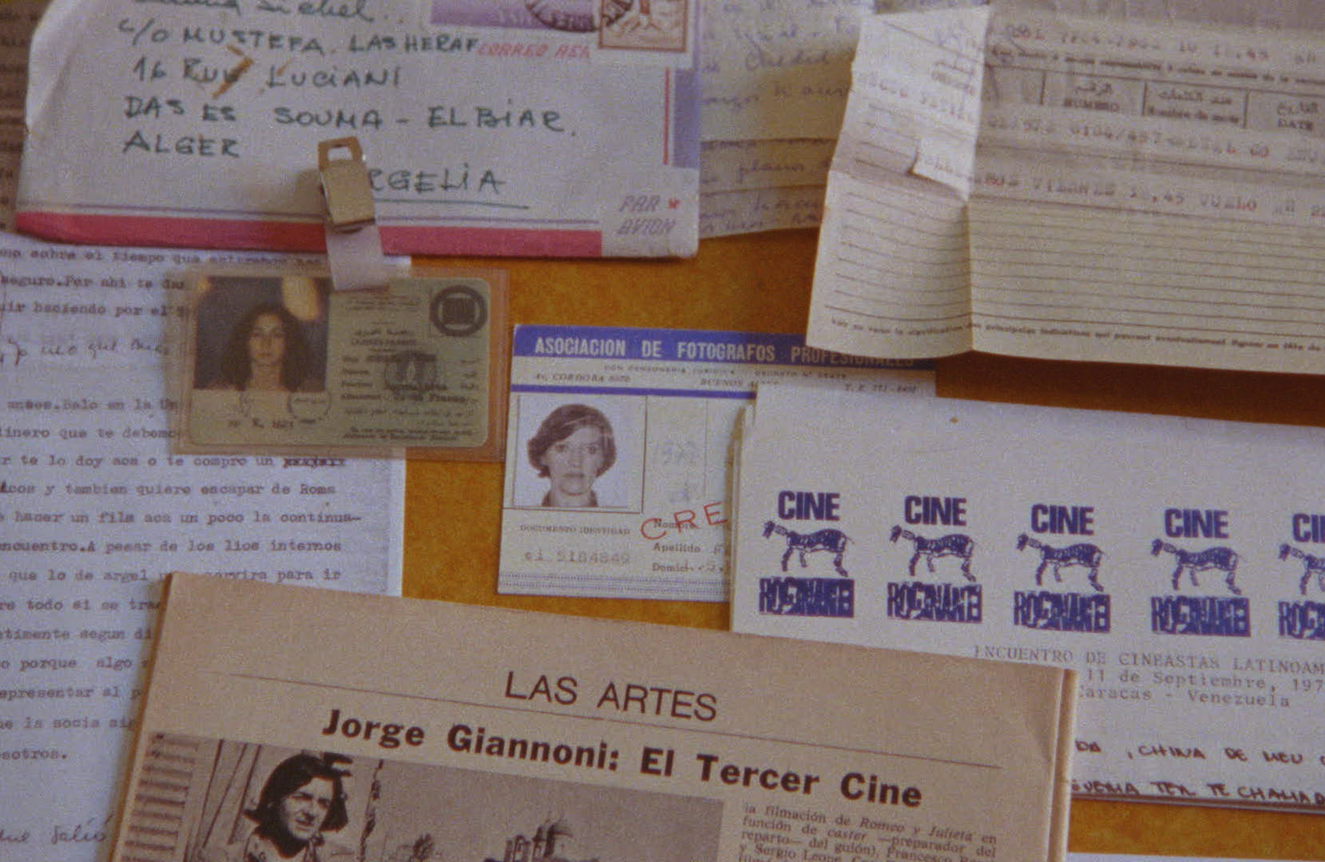 A photograph of documents, notes, and IDs assembled on a table