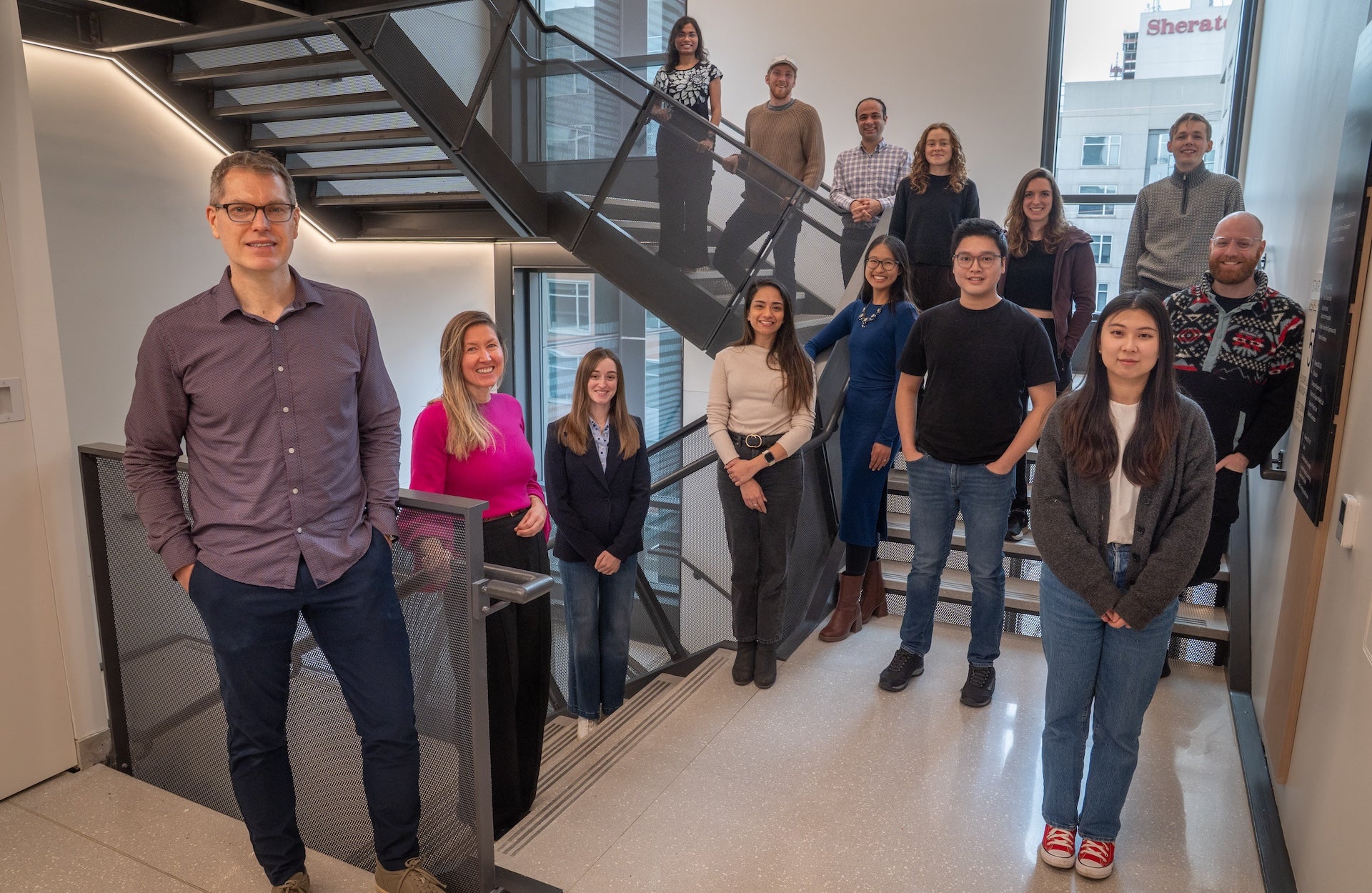 Members of the Computational Social Science Lab pose in a stairwell