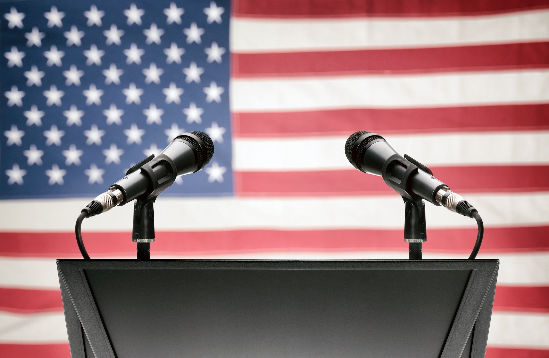 Pulpit with microphones and U.S. flag in background