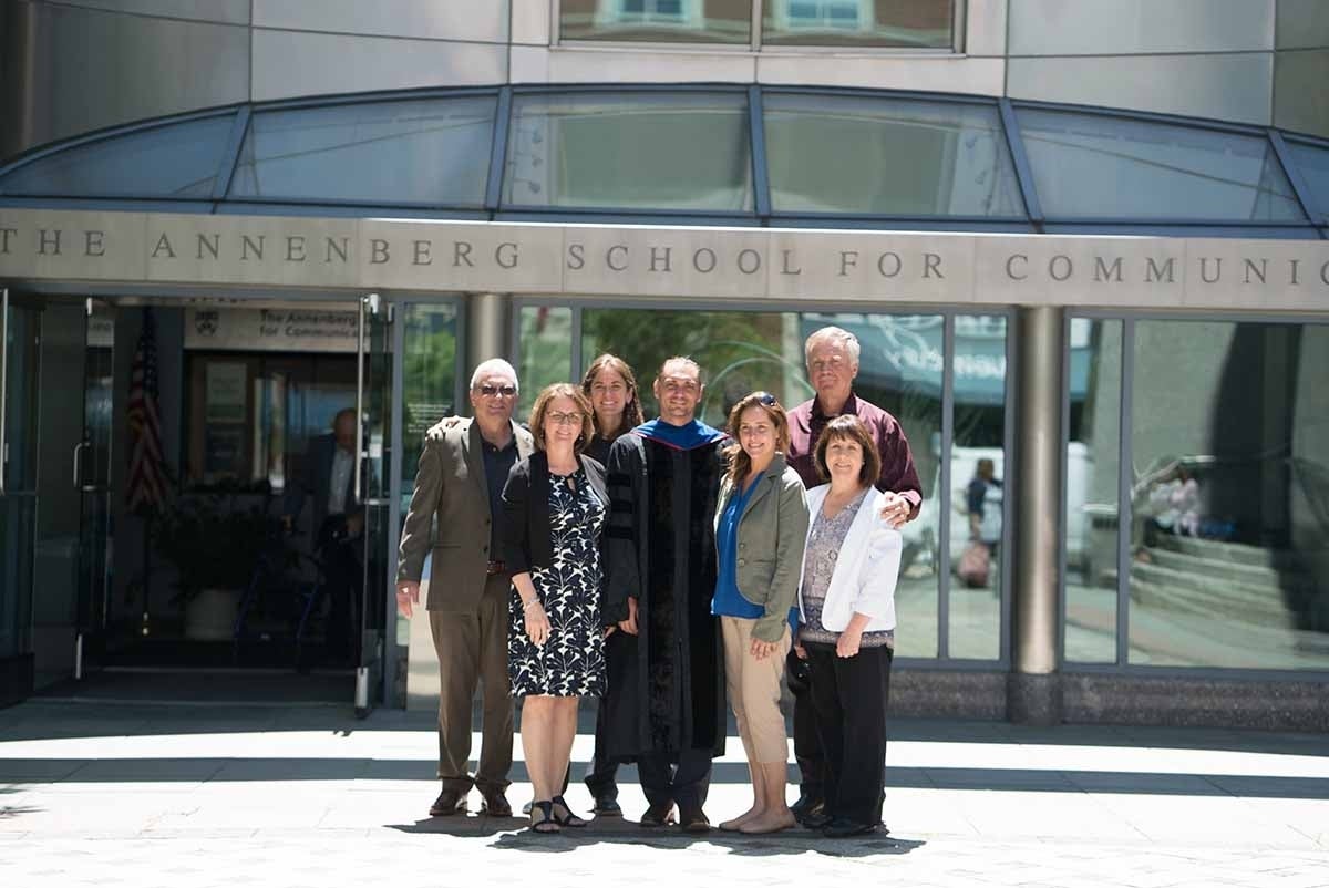 Photo of Emily Falk with former advisee and lab member Chris Cascio (Ph.D. '17) and his family