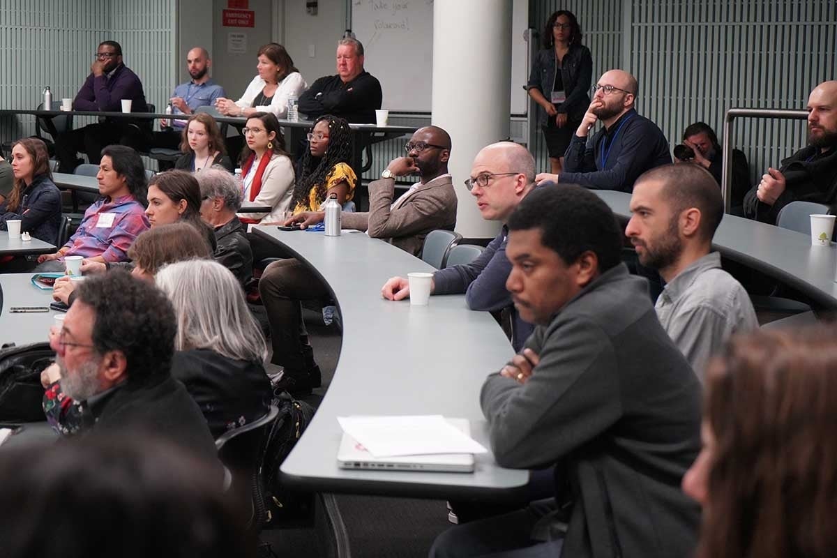 Photo of audience listening to a speaker