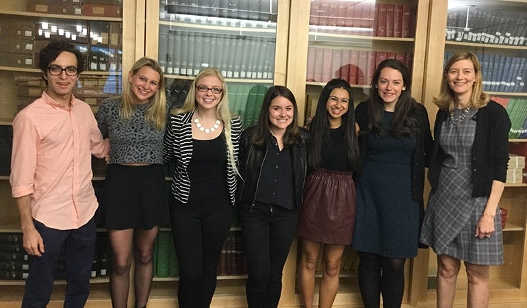 Undergraduates pose for photo with thesis advisor