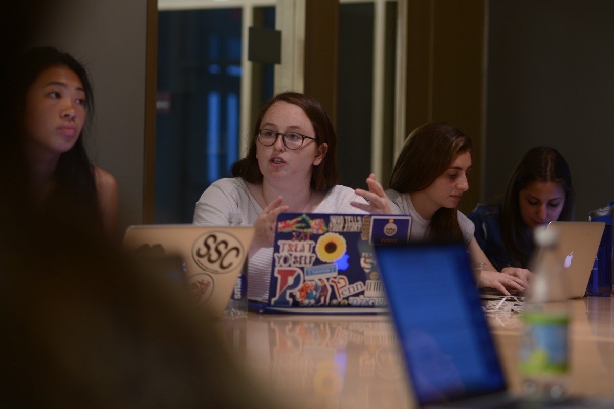 Sophie Beren speaking to someone to her right, making use of her hands