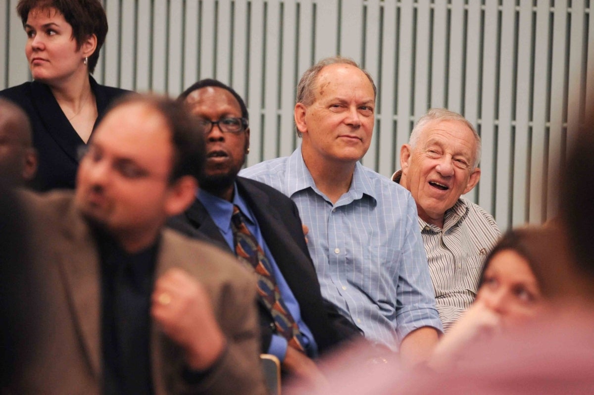 Elihu Katz smiling at something during a lecture, with many people around him also looking in the same direction