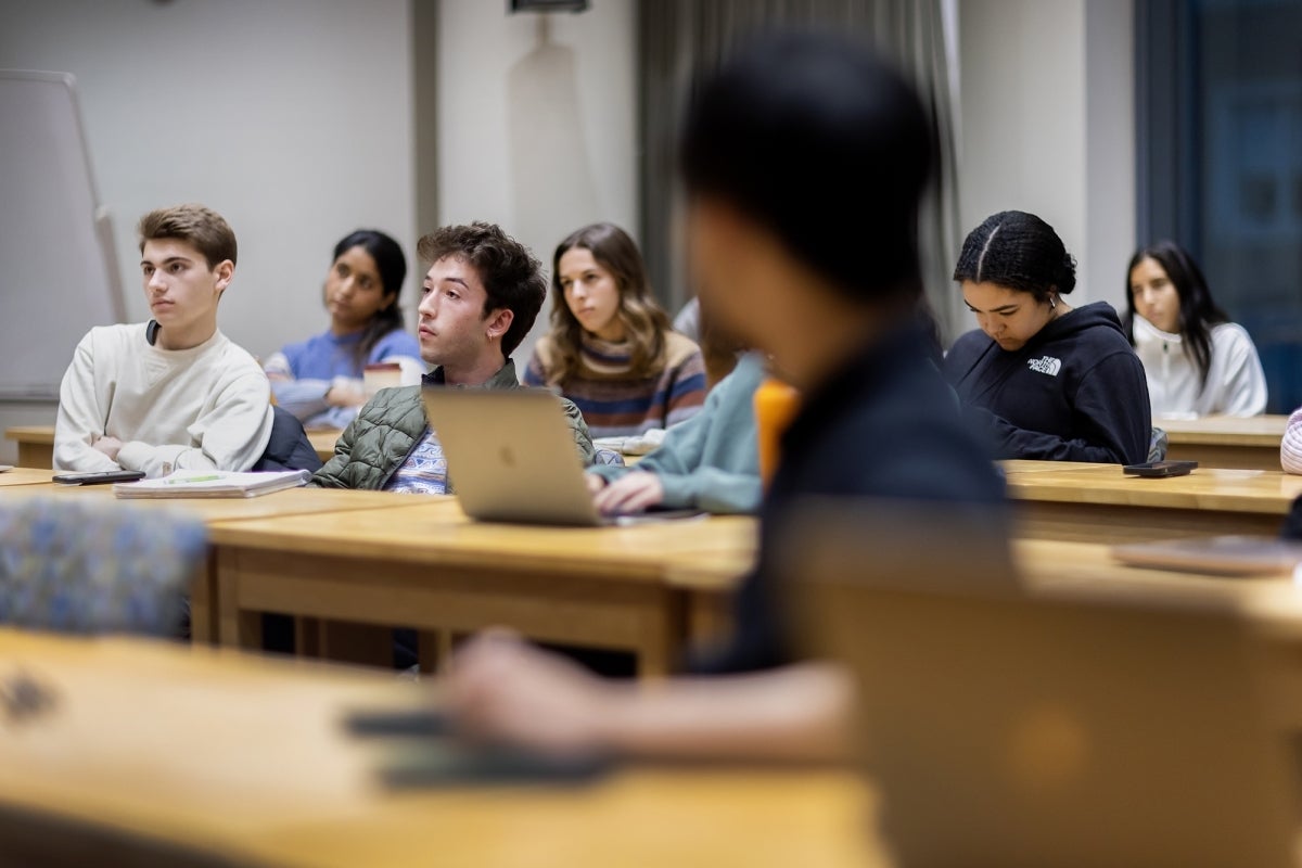 A student in the front turns around to listen to Max Cass speak