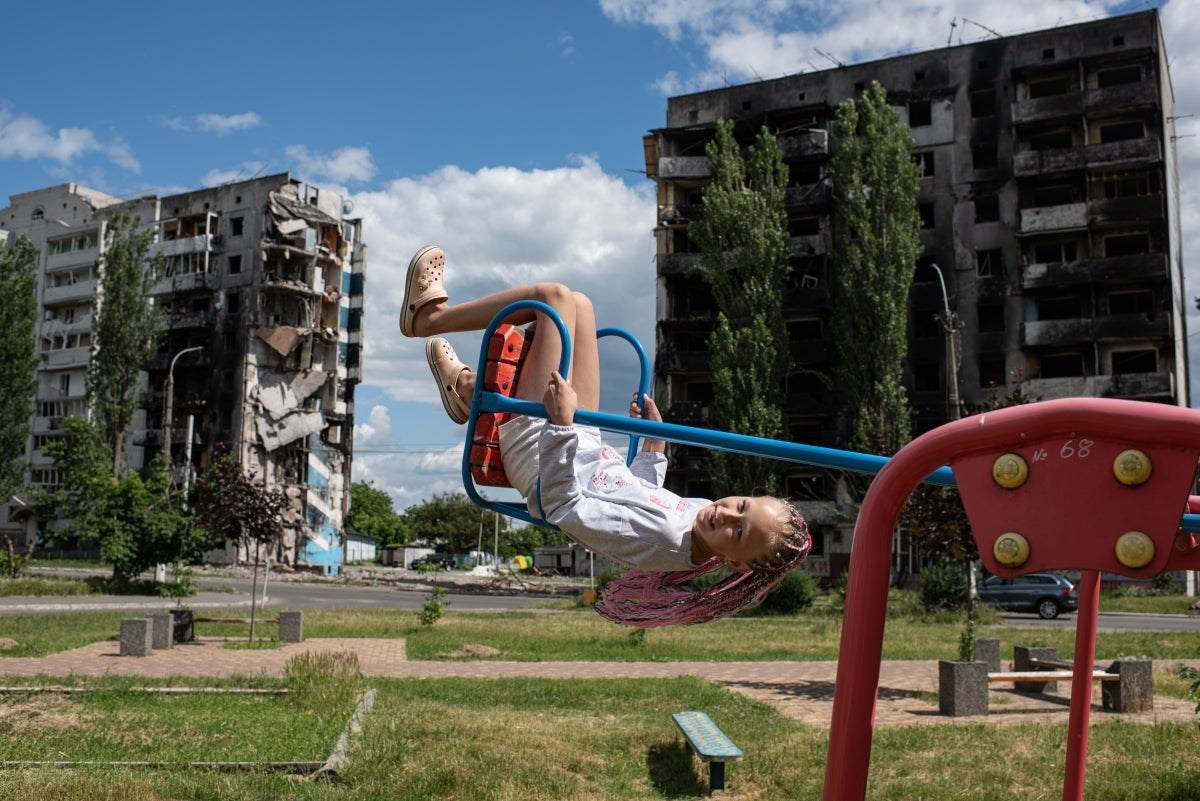 A girl plays on a swing in Borodianka, Kyiv region in June 2022. (Photo: Alexey Furman)
