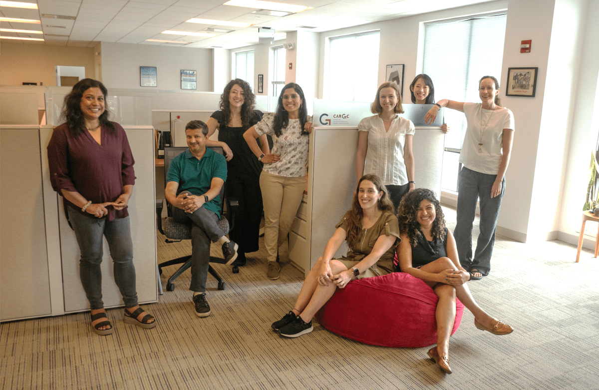 CARGC residents and CARGC staff pose in front of cubicles in the CARGC office