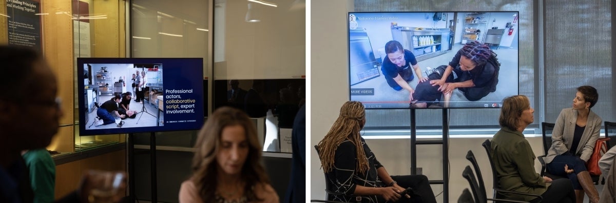 Groups of people watch a video of actors portraying a man overdosing and people helping him by administrating Narcan