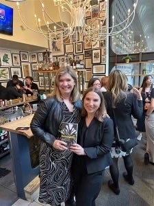 Sarah Banet-Weiser and Kat Higgins hold their book, 'Believibilty'