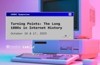 90s Computer with an old style memo box that has the title of the Symposium
