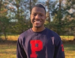 Winston Britton 700 x 550.jpg Winston Britton outdoors in a navy sweatshirt with a red P