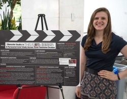 Thesis student 700 x 550.jpg Student standing next to a poster presenting her thesis. The title is "Character Deaths in This is Us, Grey's Anatomy or Game of Thrones: A Parasocial Grief Study Across Three Television Dramas