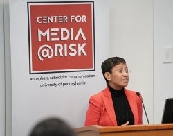 Maria Ressa Center for Media at Risk 700 x 550.jpg Maria Ressa speaking at a podium with a "Center for Media at Risk" banner behind her