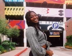 Raven 700 x 550.jpg Raven Sulaimon posing in front of a colorfully-painted parking garage