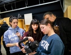 AC_CamraFellowship_700x550.jpg Three women and one man looking at footage on a large video camera