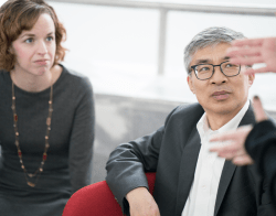 DMSI_Checkerboard2.png A professional woman and man looking at someone out of view