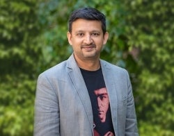 Aswin 700 x 550.jpg Aswin Punathambekar standing in front of some ivy