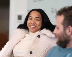 Fallon 700 x 550.jpg Student smiling while seated. another person listens